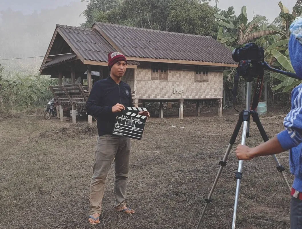 Project Video crew filming on location with a clapperboard at a rural shoot