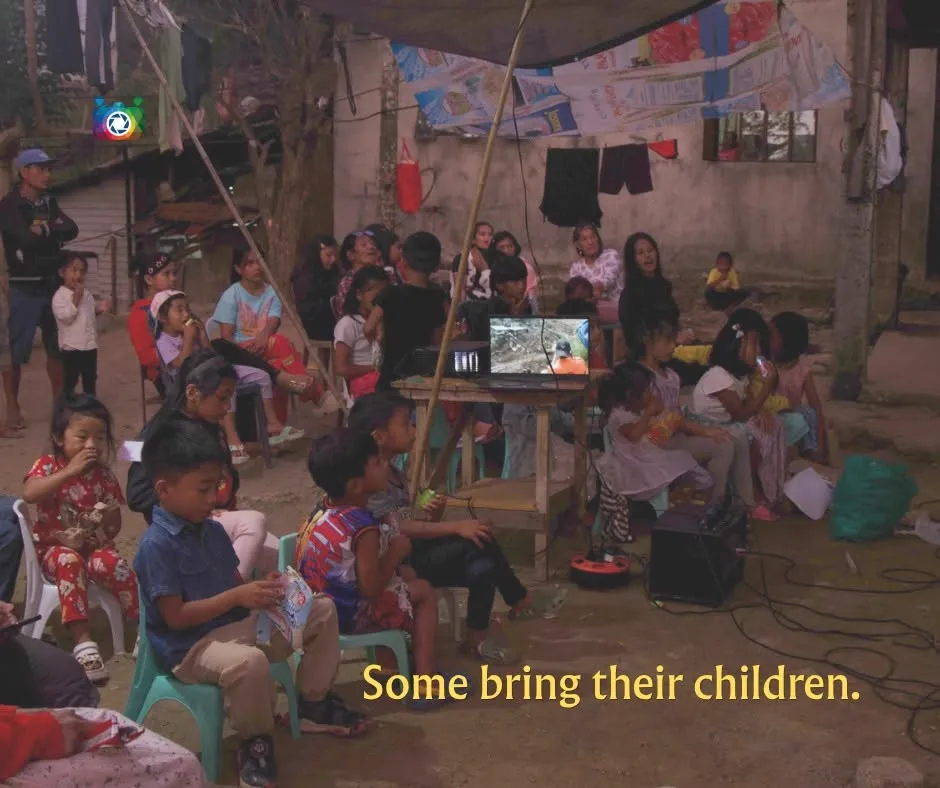 Some bring their children — families with young kids seated around a small screen