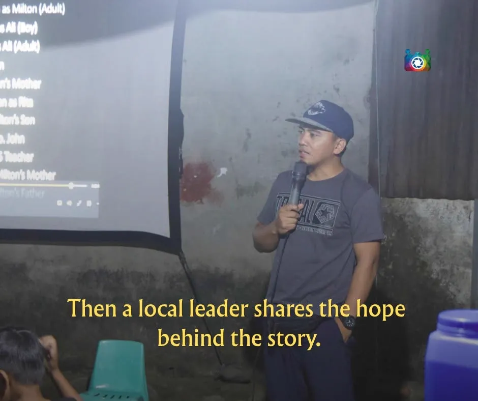 Then a local leader shares the hope behind the story — a man speaking into a microphone after the screening