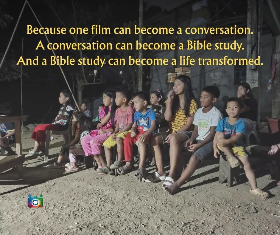 Because one film can become a conversation, a conversation a Bible study, and a Bible study a life transformed — a young woman talking with a group of children at night